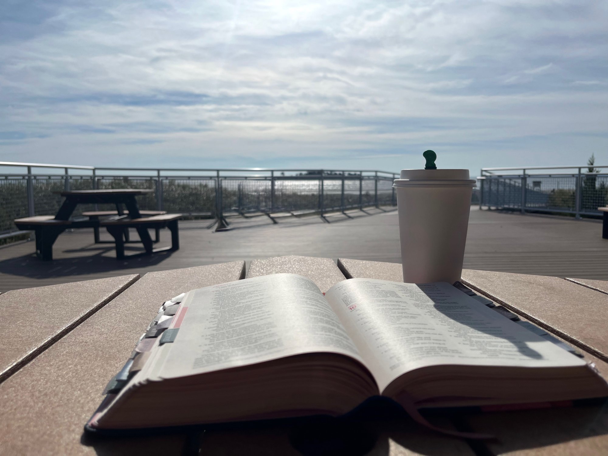 Bible and coffee by the ocean